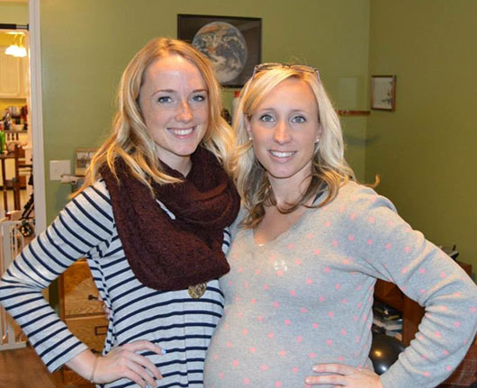 Two women, one pregnant standing beside each other