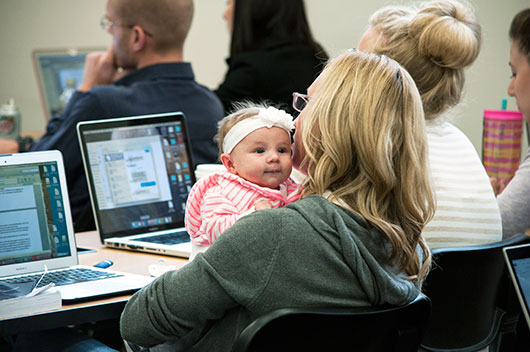 Joni Bodnar with her newborn daughter in class at KU Law.