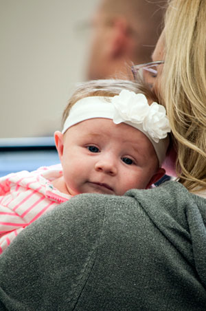 Closeup photo of Joni Bodnar with her newborn daughter in class at KU Law.