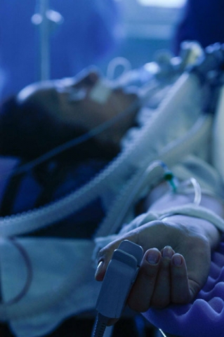 Medical equipment or supplies under blue lighting in what appears to be a clinical environment.