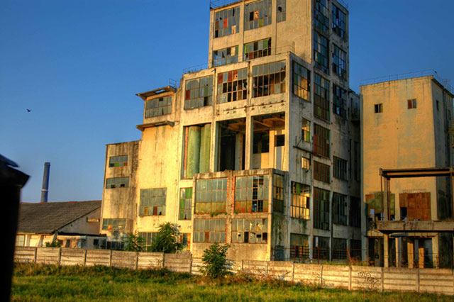 A yellow multi-story building or structure that appears to be in an urban setting.