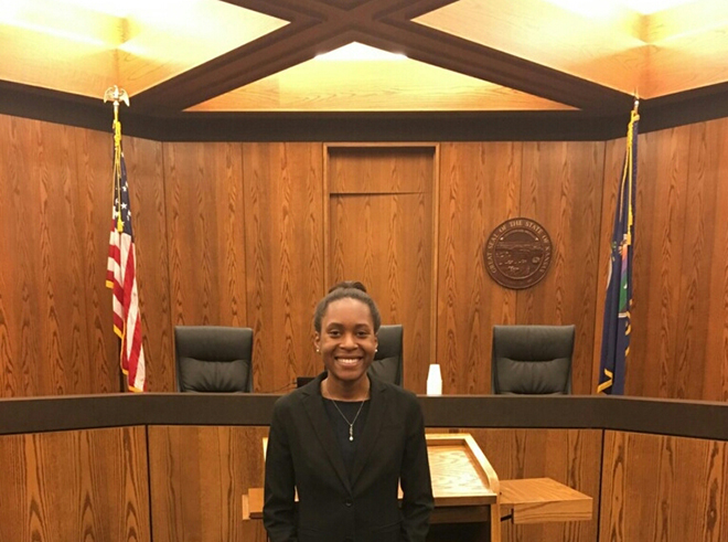 Malika Baker standing in a court room