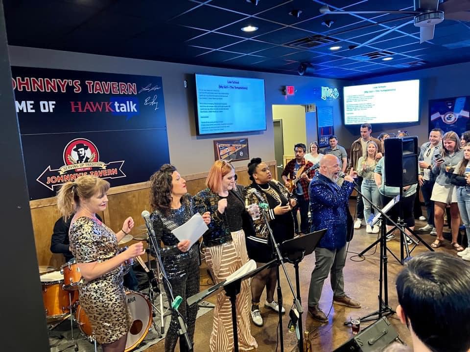 Faculty, staff, and students perform with The Moody Bluebooks at Johnny's Tavern