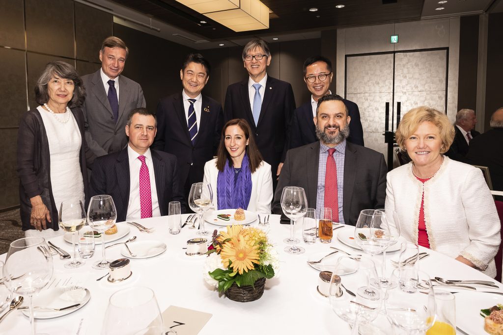A group of people gathered around a table at a dinner event