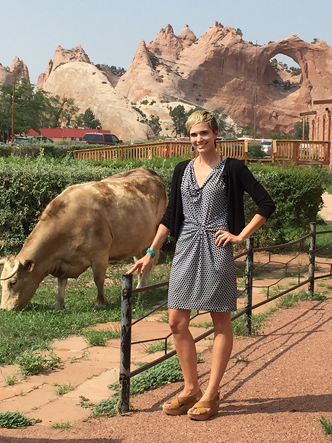 Becky Howlett stands by a bull eating grass