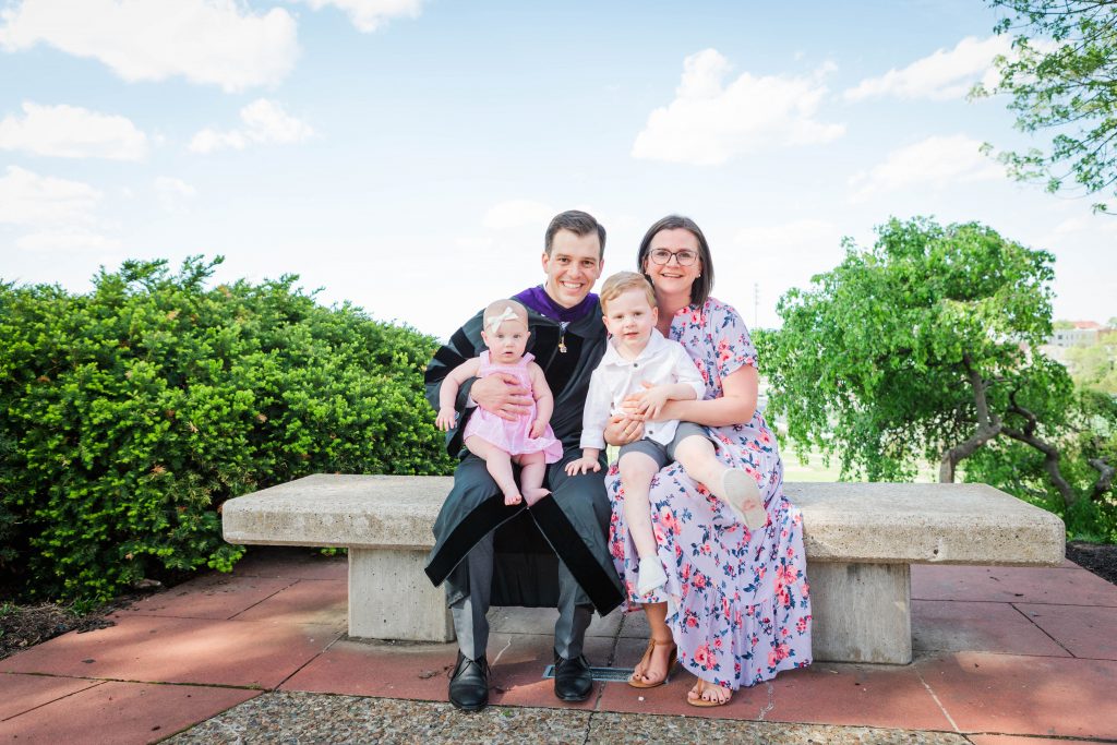 Blake Saffels in graduation regalia with his family