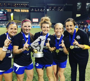 Caroline Kastor and some of her FC Kansas City Blues on the field.