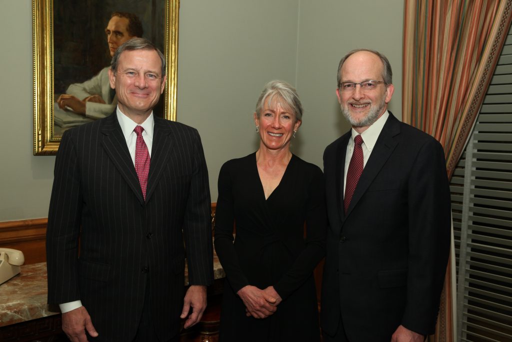 Steve Leben standing next to Ann Warner and John Roberts in an office