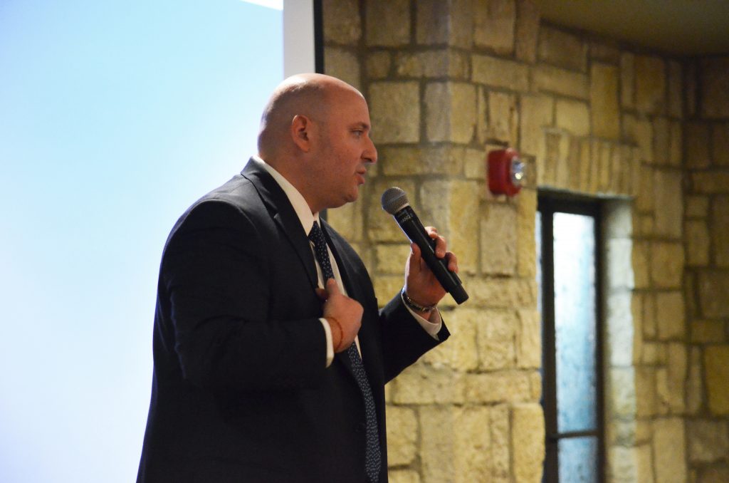 Luis Gomar speaking into a mic