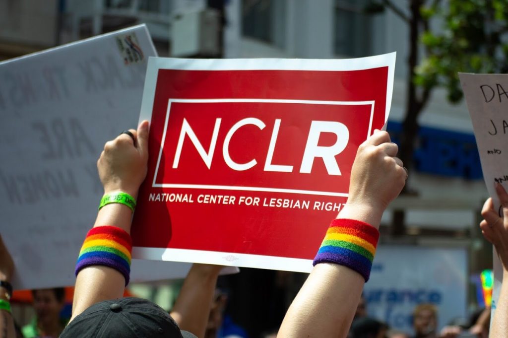 Someone holding up a sign for the 'National Center for Lesbian Rights'