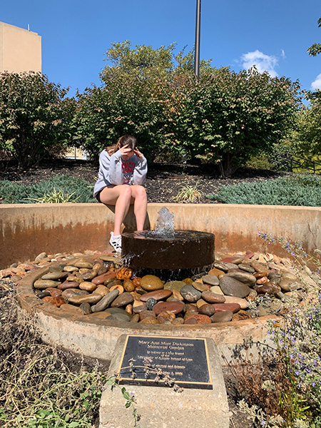 Student crying in Mary Ann Mize Dickinson Memorial Garden