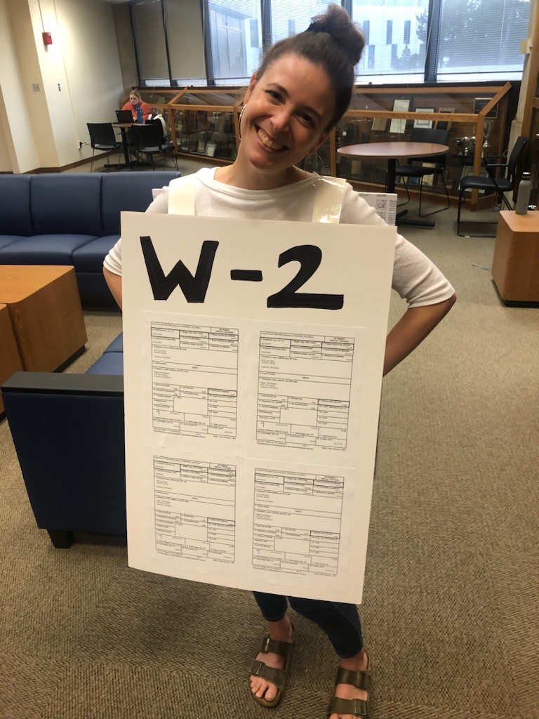 Kat Girod holding a large sized W-2 Form