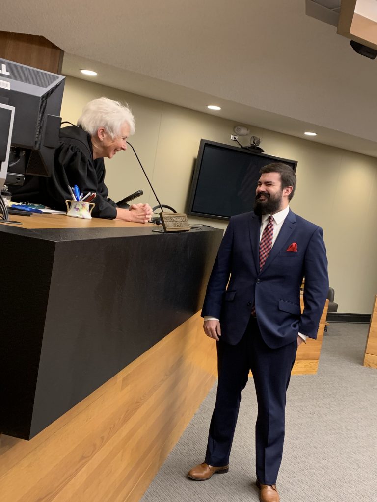 Sally Pokorny talking to Jackson Ely at a desk