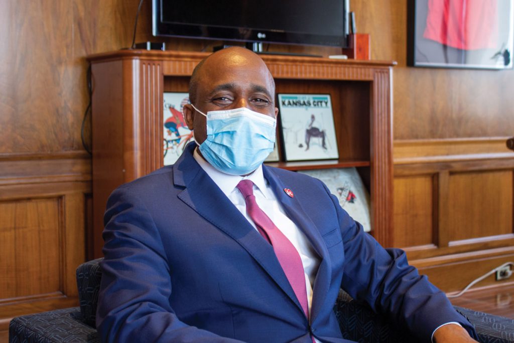 Quinton Lucas sitting in an office wearing a mask.