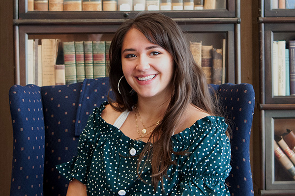 Libby Rohr in front of a bookshelf