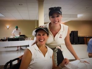 Miranda Luster standing with Betsy Mellor in golf uniforms