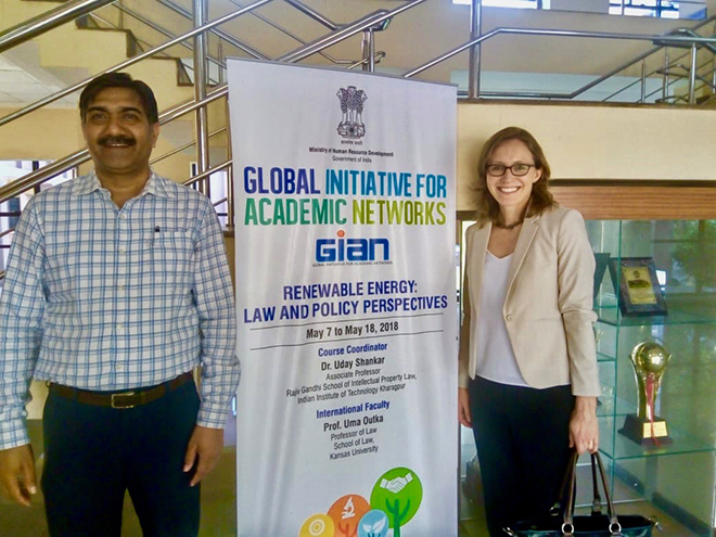 Uday Shankar and Uma Outka stand by a sign for their two week course