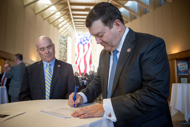 Stephen McAllister signing a document