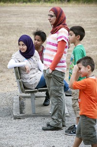 Zainab Radhi and family outdoors around a bench
