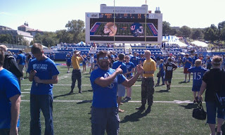 Group of fans on the field of Booth memorial stadium as viewed from the field