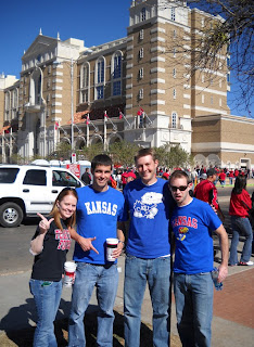 Four people outside in various team apparel 