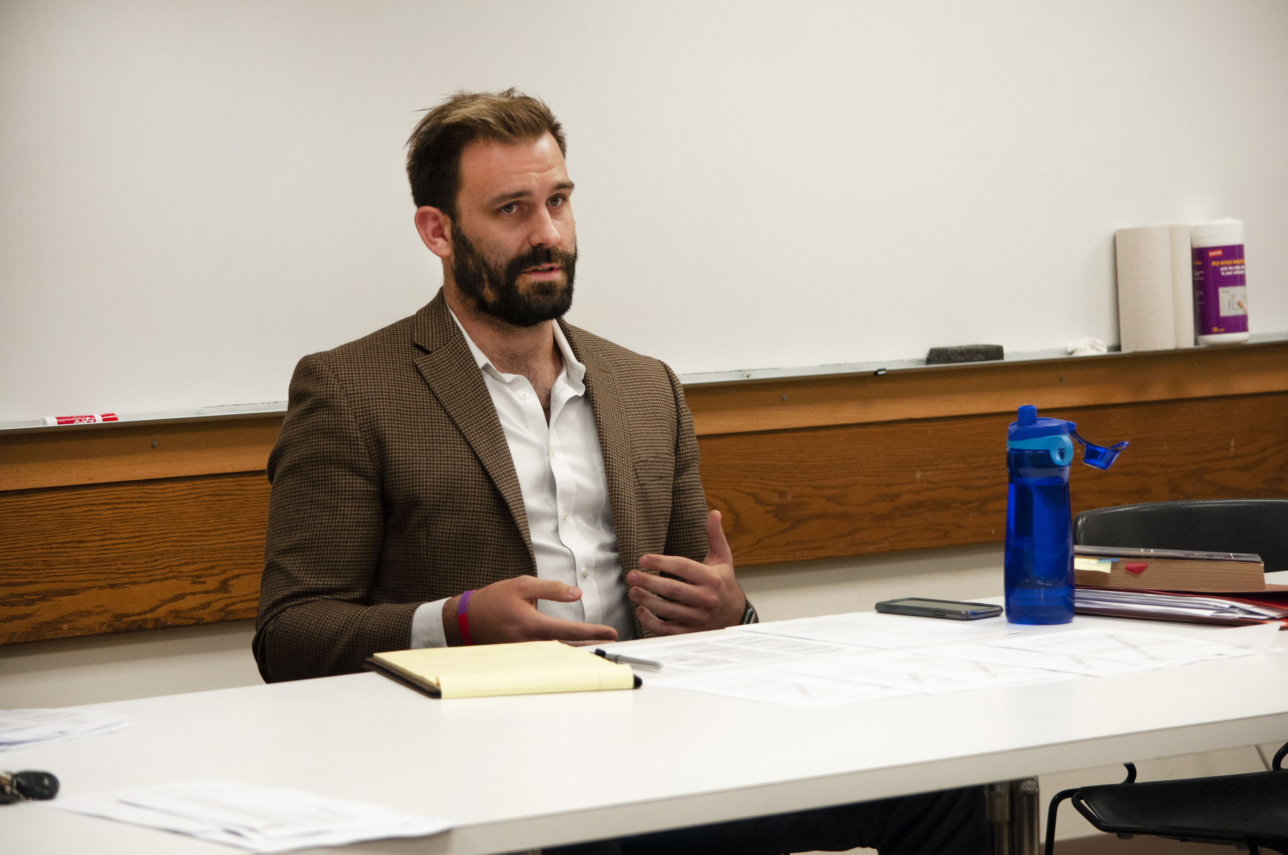 Bill Walberg speaking while seated at a table