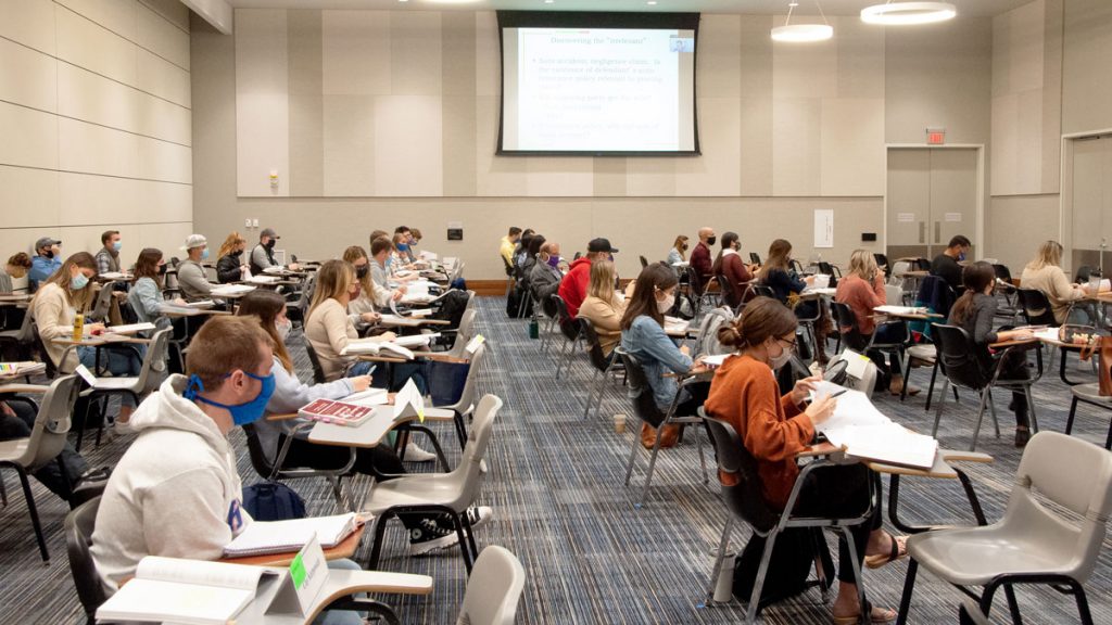 socially distanced students with masks at desks