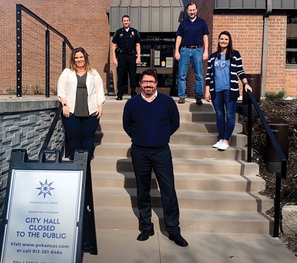 Five people socially distanced on a steps to Prairie Village City Hall