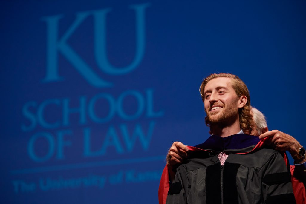 Nate Crosser, L'19, is hooded at KU Law's graduation ceremony on May 18, 2019.