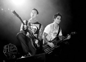 Two people playing electric guitars