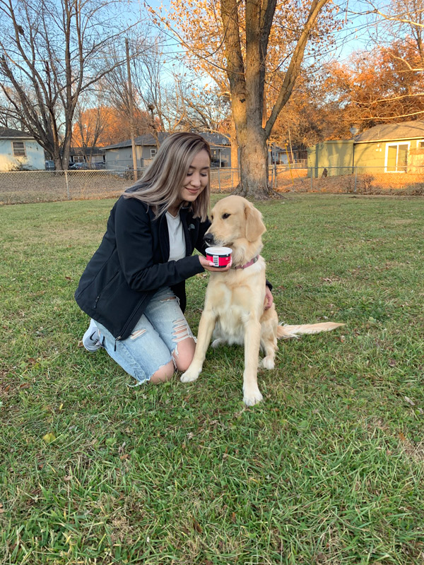 Jamie Treto and her dog Bella having a treat