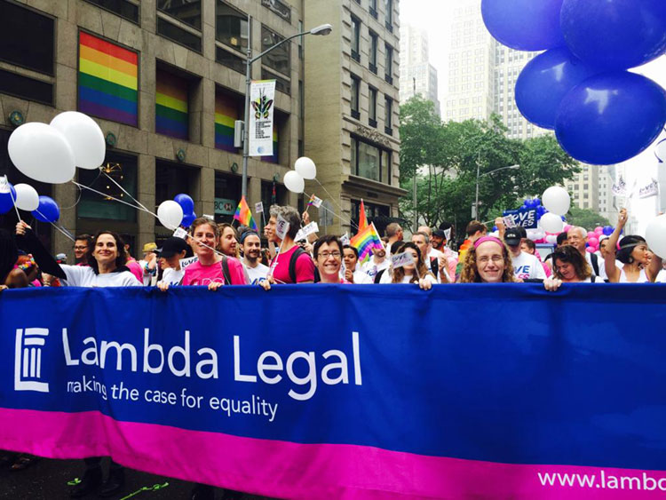 KU Law student Jessica Frederick and fellow interns hold the Lambda Legal banner during NYC's PrideFest parade