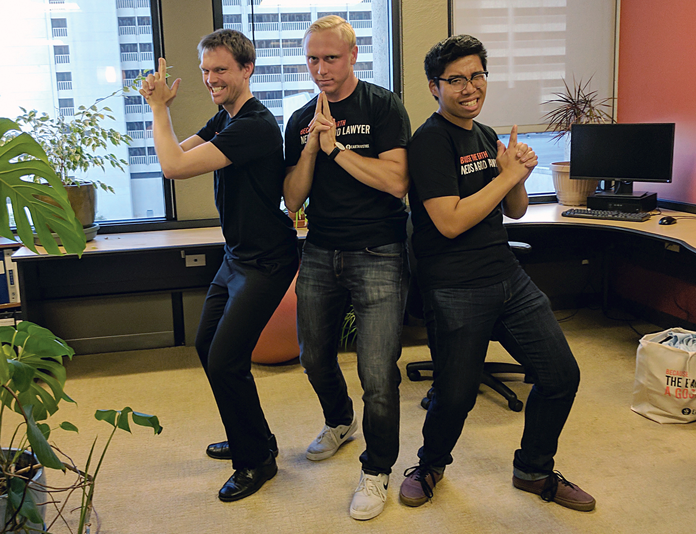 KU Law 3L John Truong at Earthjustice in silly finger-gun spy pose with peers 