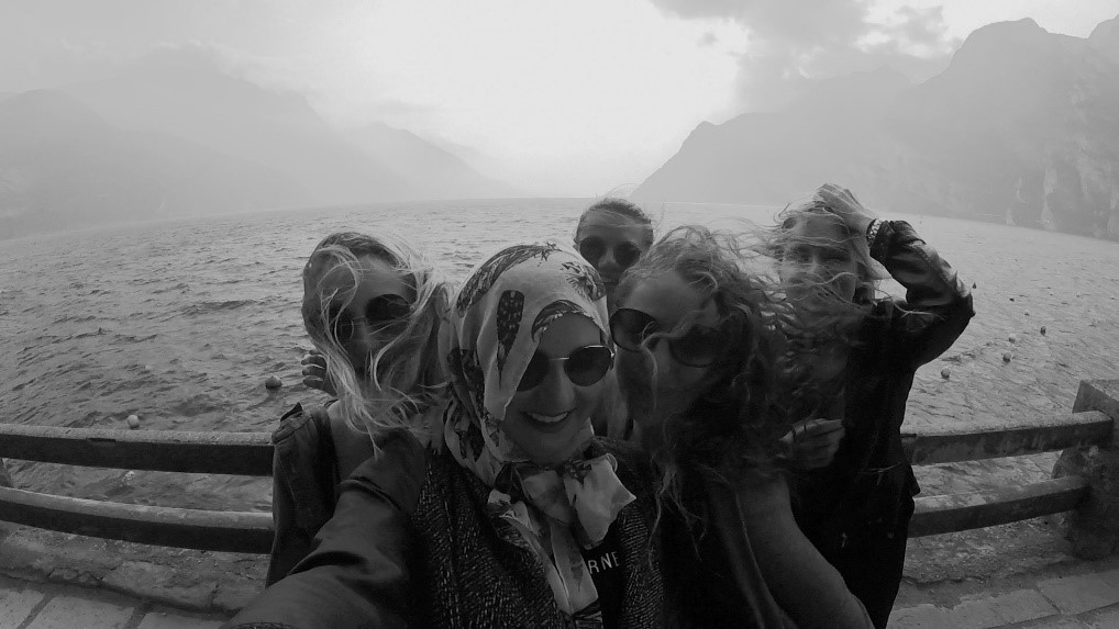 Friends in front of a windy, foggy lake.