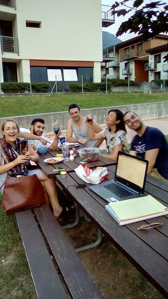 Friends at outdoor picnic table.