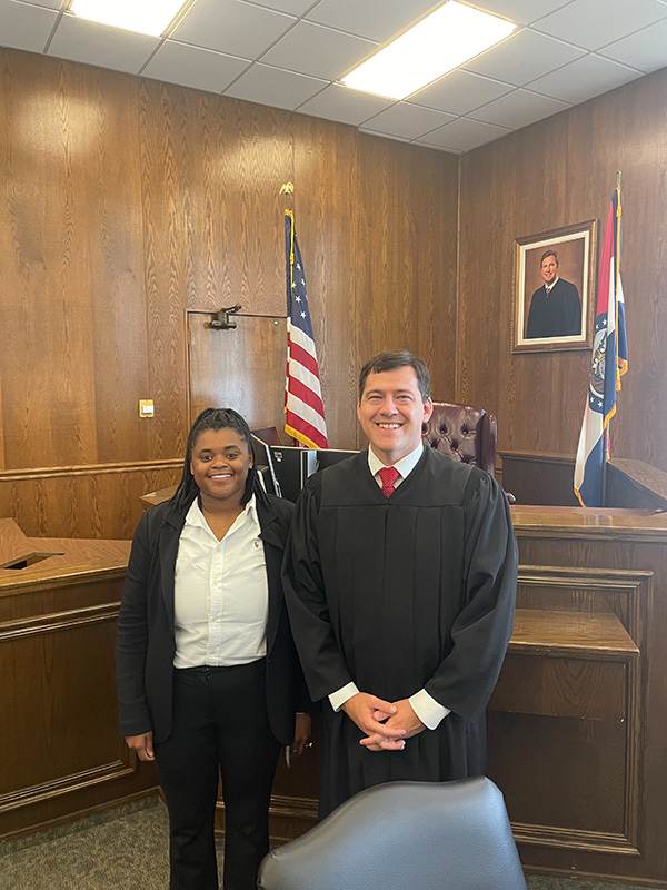 Terra Brockman, left, with Hon. Adam L. Caine.