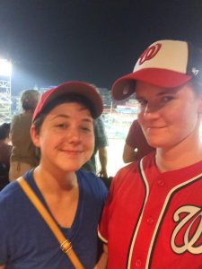 Malone and Bunner wearing baseball caps at stadium at night.