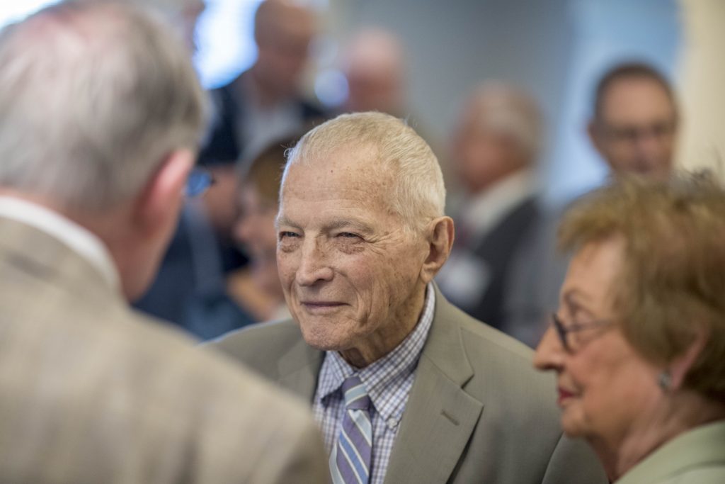 Donald Giffin, center, talks with fellow KU Law alumni at the 2018 50/50+ Reunion Dinner.