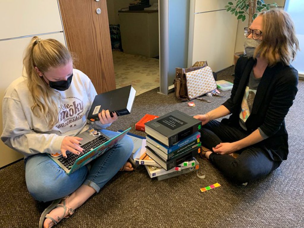 FGP leadership team labels donated textbooks