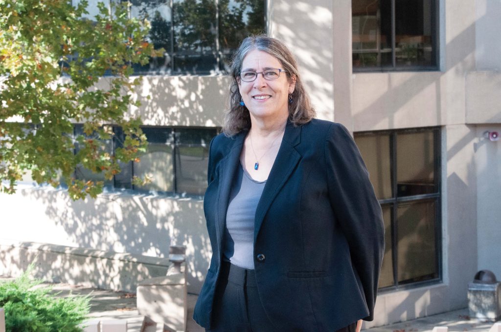 Marilyn Harp, L'79, stands in front of Green Hall.