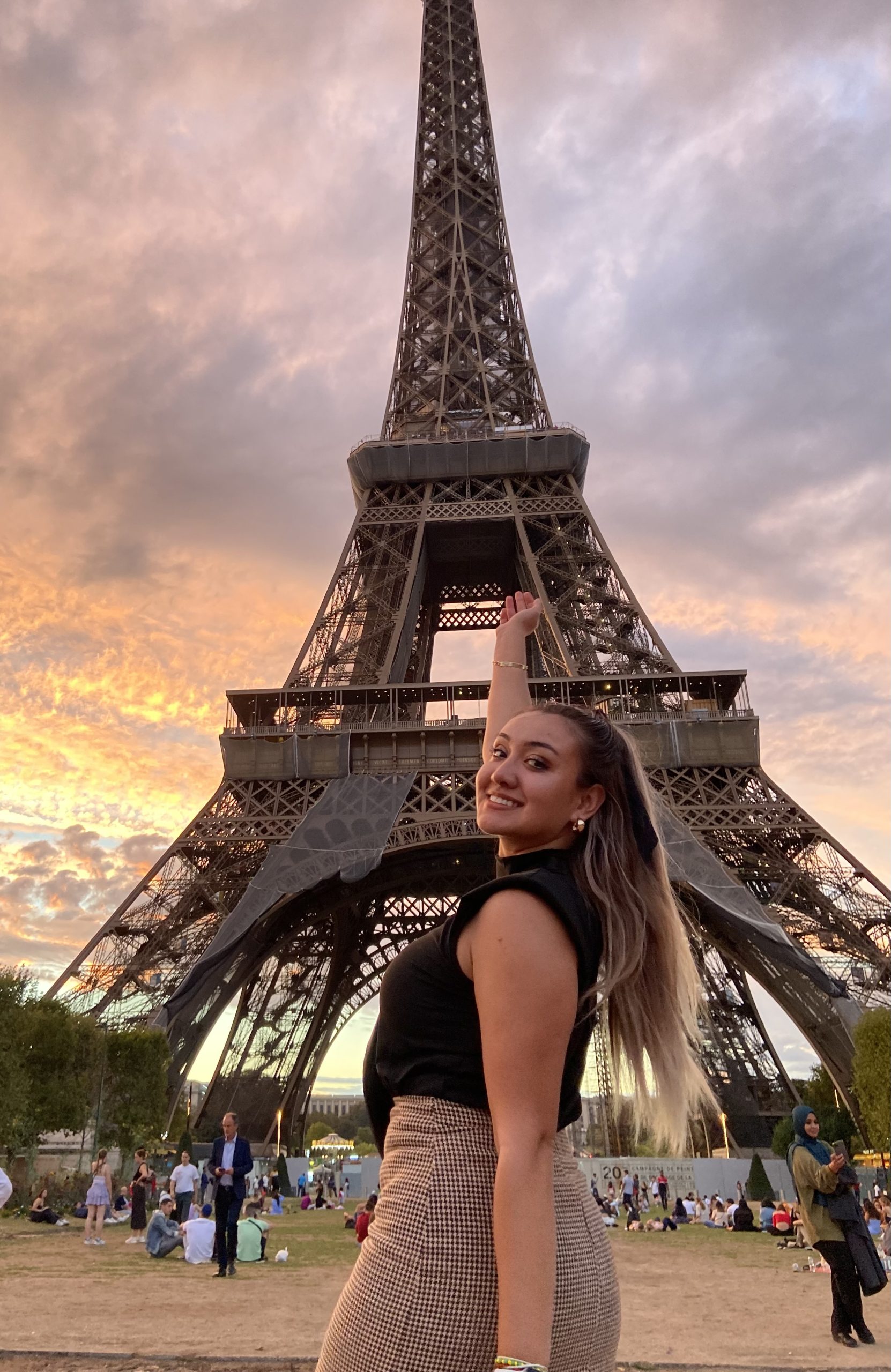Jamie poses in front of the Eiffel Tower as the sun sets.